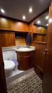Slide: The Image of Luxurious bathroom in 2002 Canoe Cove 50 Pilothouse Yacht with wood accents and modern fixtures. - 31