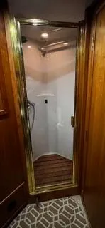 Slide: The Image of Shower area in 2002 Canoe Cove 50 Pilothouse Luxury Yacht with wooden accents. - 32