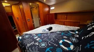 Slide: The Image of Luxurious bedroom interior of 2002 Canoe Cove 50 Pilothouse Yacht with nautical-themed bedding. - 35