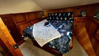 Slide: The Image of Luxurious bedroom in 2002 Canoe Cove 50 Pilothouse Yacht with nautical-themed bedding. - 36