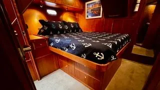 Slide: The Image of Luxurious bedroom in 2002 Canoe Cove 50 Pilothouse Yacht with anchor-themed bedding. - 37