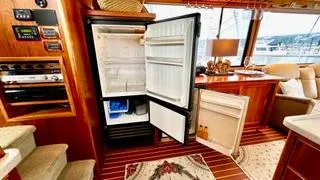 Slide: The Image of Luxurious interior of 2002 Canoe Cove 50 Pilothouse Yacht with open fridge. - 38