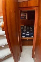 Slide: The Image of Interior view of 2002 Canoe Cove 50 Pilothouse Yacht with wooden finish and nautical-themed bedding. - 39