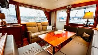 Slide: The Image of Luxurious interior of 2002 Canoe Cove 50 Pilothouse Yacht with plush seating and elegant decor. - 41