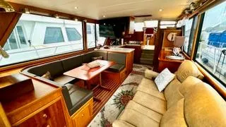 Slide: The Image of Luxurious interior of a 2002 Canoe Cove 50 Pilothouse Yacht with elegant seating and dining area. - 42