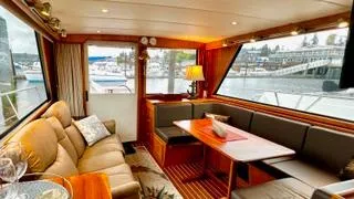 Slide: The Image of Luxurious interior of 2002 Canoe Cove 50 Pilothouse Yacht with elegant seating and dining area. - 43