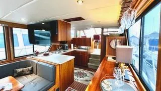 Slide: The Image of Luxurious interior of a 2002 Canoe Cove 50 Pilothouse Yacht with elegant wood finishes. - 44