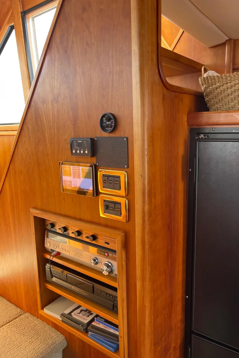 Slide: The Image of Interior of 2002 Canoe Cove 50 Pilothouse Yacht with wooden paneling and control instruments. - 45