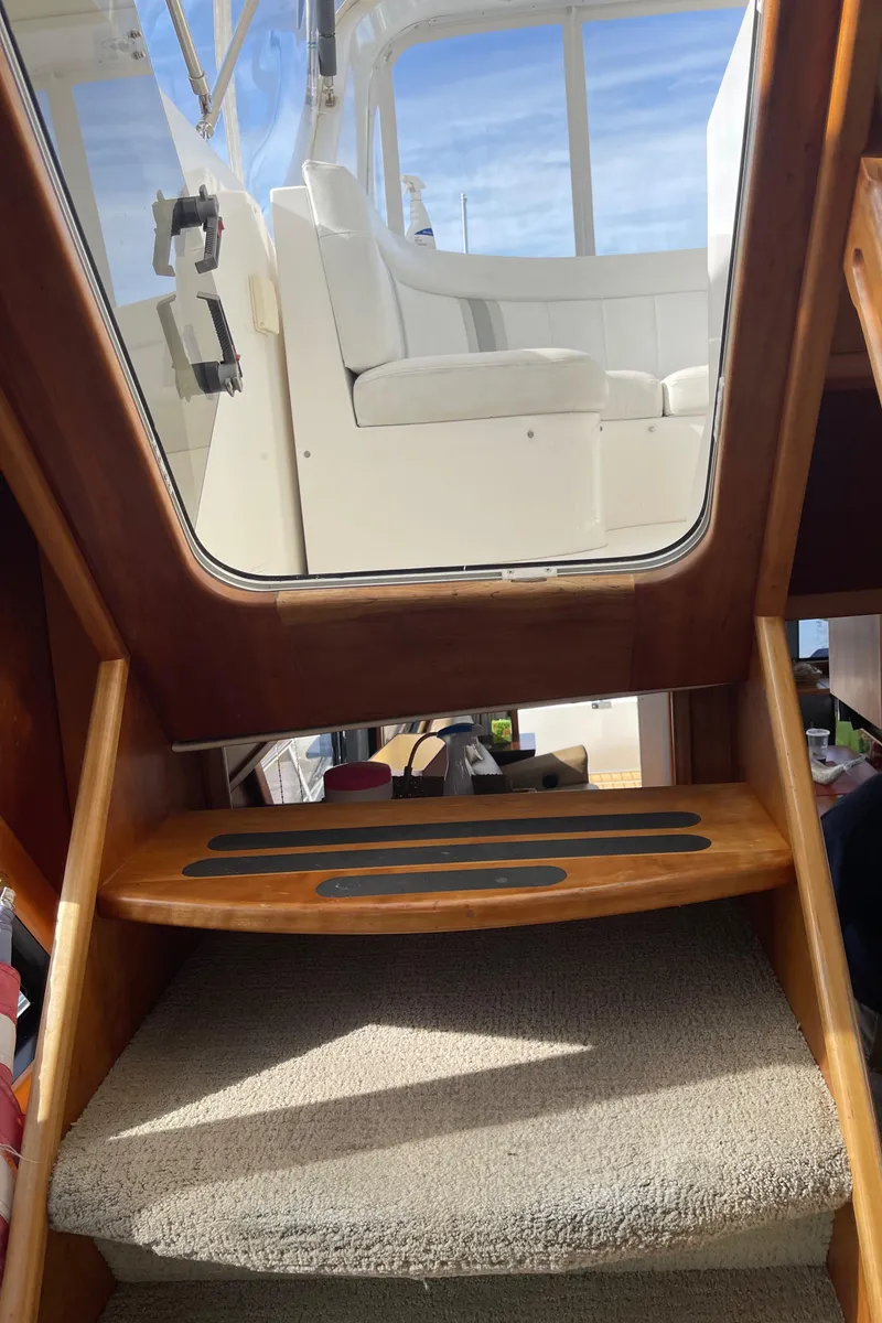 Slide: The Image of Interior view of 2002 Canoe Cove 50 Pilothouse Yacht, showing stairs and seating area. - 46