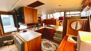 Slide: The Image of Luxurious interior of a 2002 Canoe Cove 50 Pilothouse Yacht with elegant wood finishes. - 47