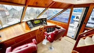Slide: The Image of Pilothouse interior of 2002 Canoe Cove 50 Pilothouse Luxury Yacht with red leather seats. - 48