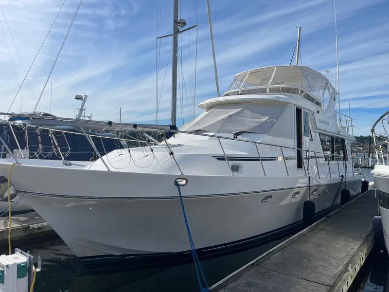 Slide: The Image of 2002 Canoe Cove 50 Pilothouse Luxury Yacht docked at marina. - 7