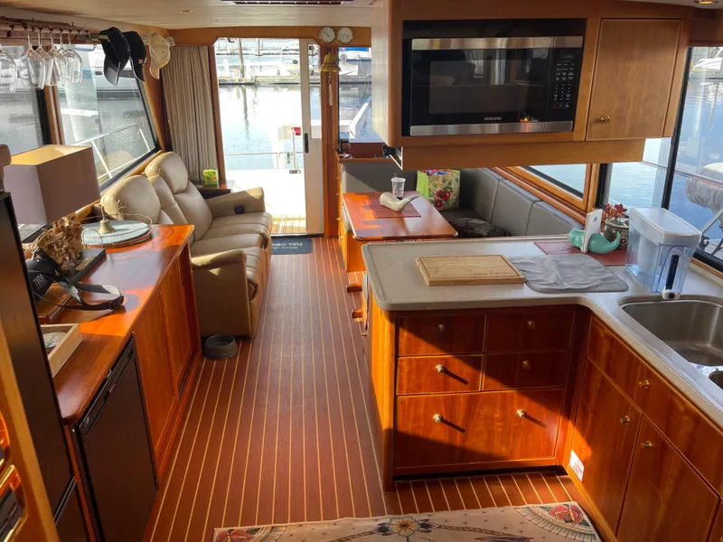 Slide: The Image of Luxurious interior of a 2002 Canoe Cove 50 Pilothouse Yacht with elegant wood finishes. - 9