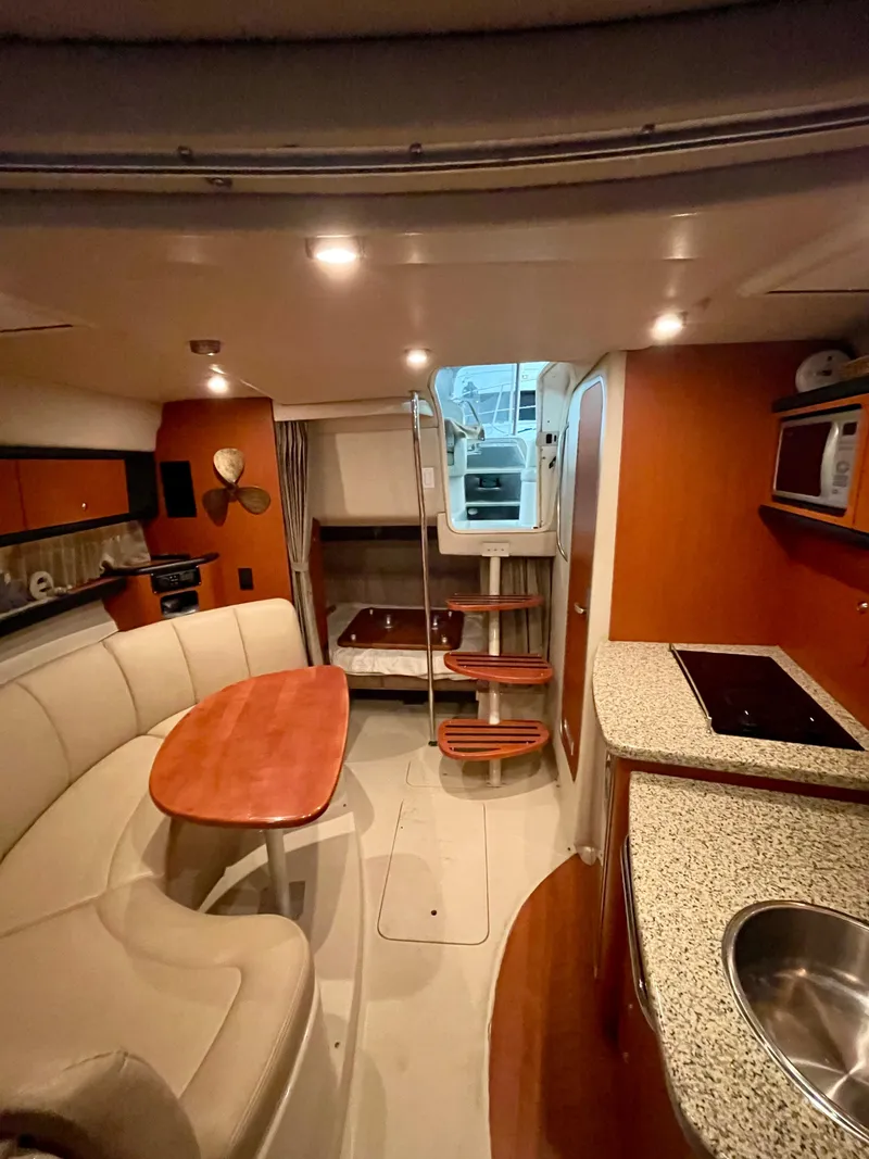 Slide: The Image of 2005 Chaparral Signature 310 interior with kitchen, dining area, and stairs. - 4