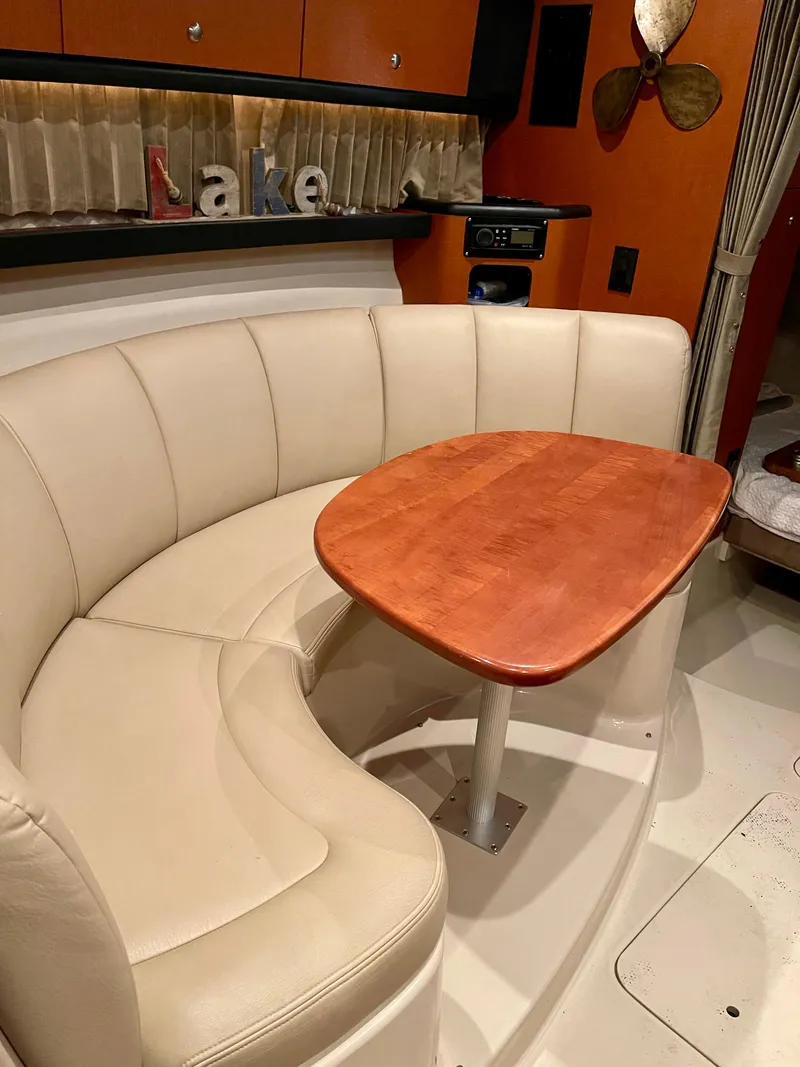 Slide: The Image of 2005 Chaparral Signature 310 interior with curved seating and wooden table. - 5