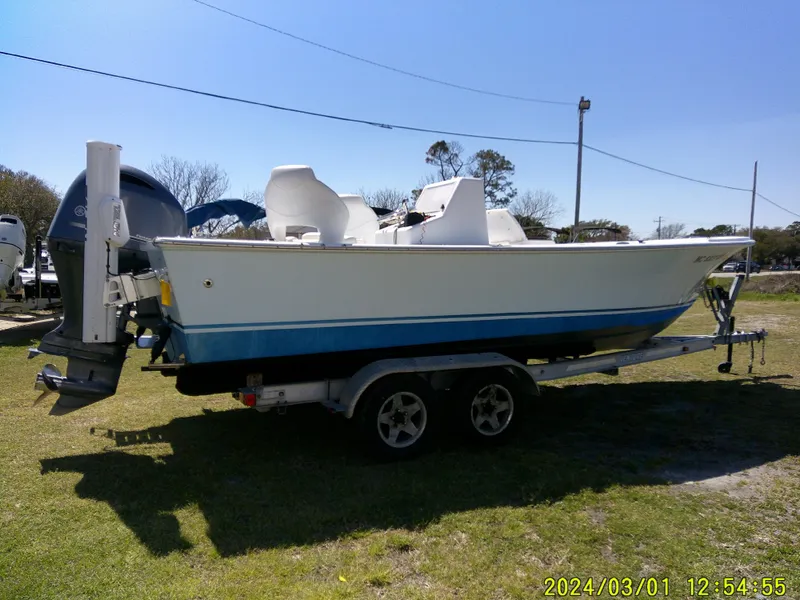 Slide: The Image of 2020 Southern Cross 23 boat on trailer, parked on grass under clear blue sky. - 11