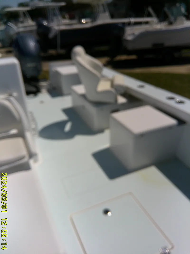 Slide: The Image of Blurry view of a 2020 Southern Cross 23 boat interior with seating and storage. - 21