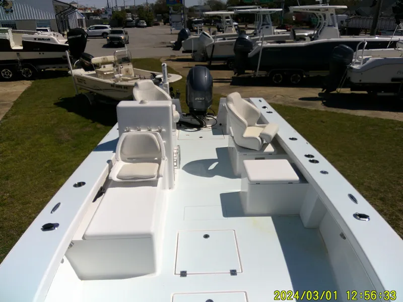 Slide: The Image of 2020 Southern Cross 23 boat with seating and motor, displayed outdoors in a marina setting. - 24