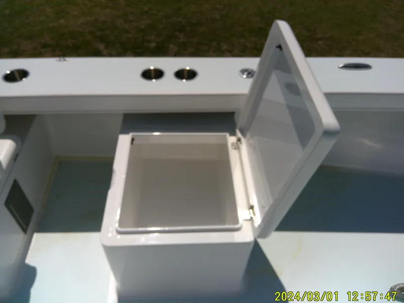 Slide: The Image of Open storage compartment on Southern Cross 23 boat, 2020 model, with cup holders. - 28