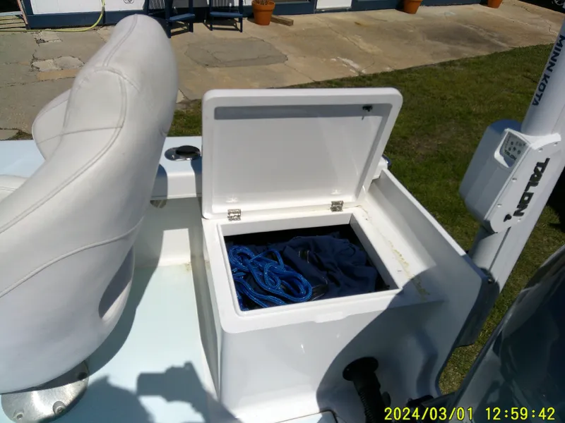 Slide: The Image of Open storage compartment on a 2020 Southern Cross 23 boat with blue rope inside. - 38