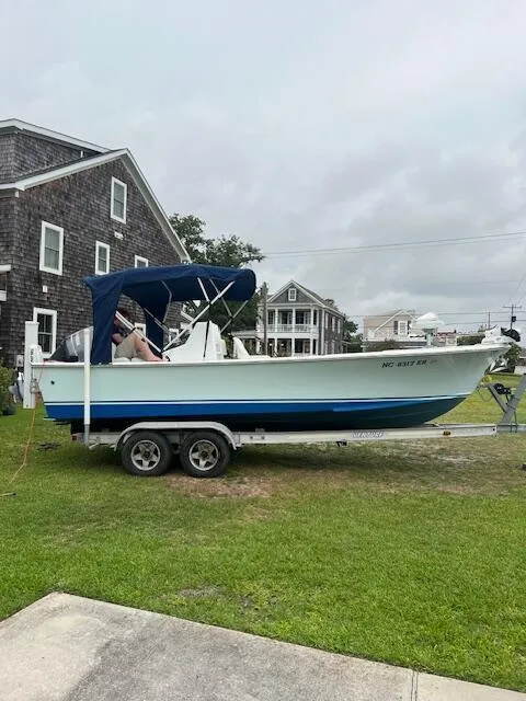 Slide: The Image of 2020 Southern Cross 23 boat on trailer, parked beside a house on a grassy lawn. - 47