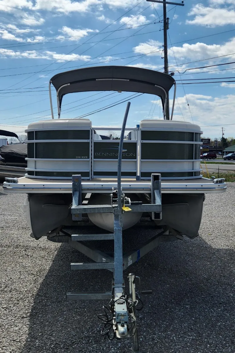 Slide: The Image of 2017 Bennington R5 2550 RCFS Saltwater Edition pontoon boat on trailer, parked outdoors. - 2