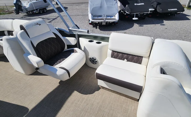 Slide: The Image of 2017 Bennington R5 2550 RCFS Saltwater Edition boat interior with plush seating and speaker system. - 8