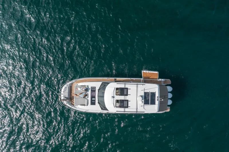 Slide: The Image of Aerial view of 2025 Jeanneau NC 1295 Coupe yacht on open water. - 26