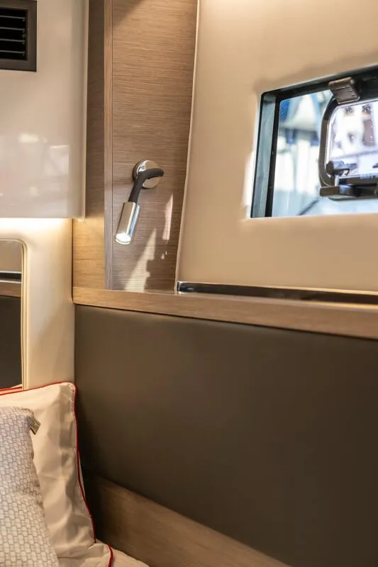 Slide: The Image of Interior of 2025 Jeanneau NC 1295 Coupe, featuring modern design and window detail. - 34