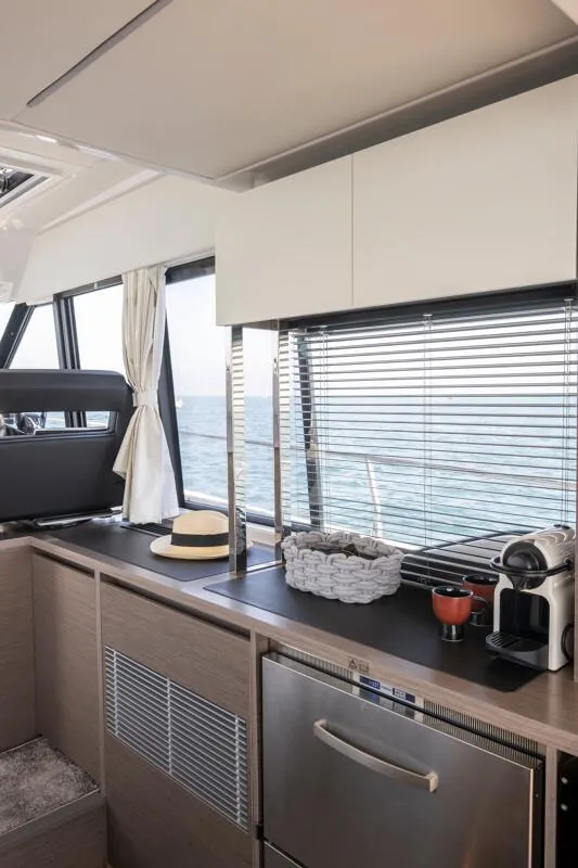 Slide: The Image of Interior of 2025 Jeanneau NC 1295 Coupe yacht with modern kitchen amenities. - 42
