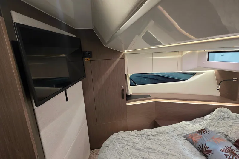 Slide: The Image of Luxurious interior of 2026 Jeanneau NC 1295 Coupe with modern design and cozy bedding. - 74