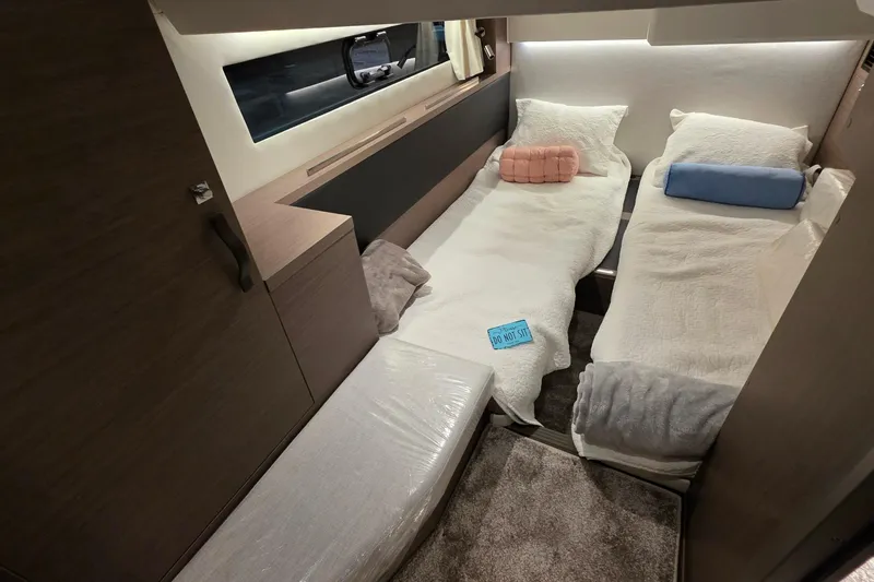 Slide: The Image of Interior cabin of 2026 Jeanneau NC 1295 Coupe with twin beds and modern decor. - 79