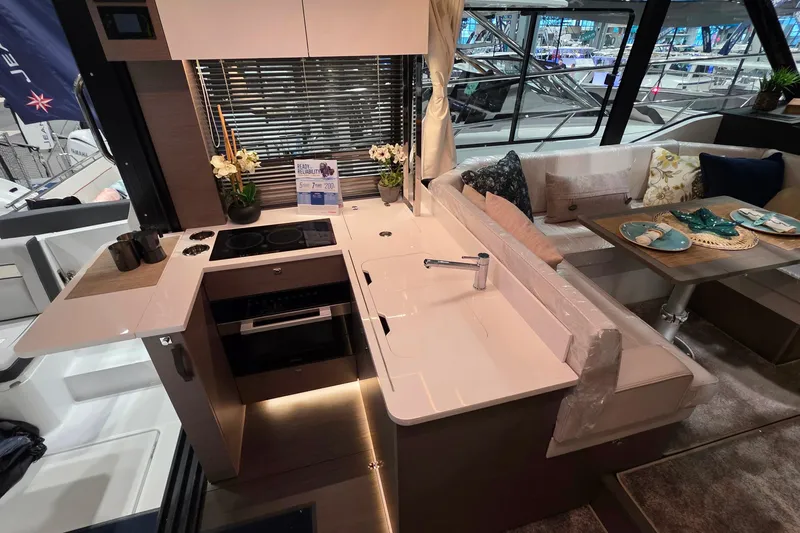 Slide: The Image of Modern kitchen and dining area inside 2026 Jeanneau NC 1295 Coupe yacht. - 83