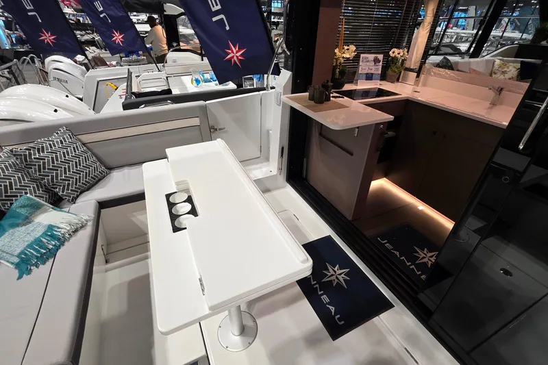 Slide: The Image of 2026 Jeanneau NC 1295 Coupe interior with modern kitchen and seating area. - 85