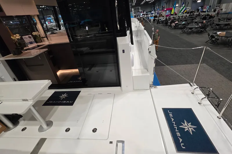 Slide: The Image of 2026 Jeanneau NC 1295 Coupe interior and deck at a boat show. - 87