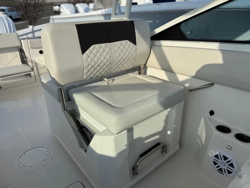 Slide: The Image of 2024 Sailfish 276 DC boat seat with quilted design and integrated storage. - 12