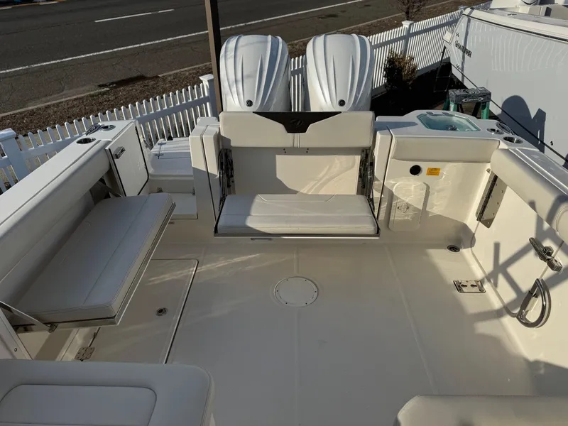 Slide: The Image of 2024 Sailfish 276 DC boat deck with seating and dual engines. - 14