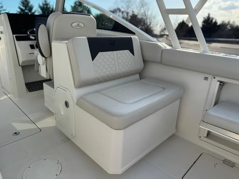 Slide: The Image of 2024 Sailfish 276 DC boat interior with cushioned seating and modern design. - 15