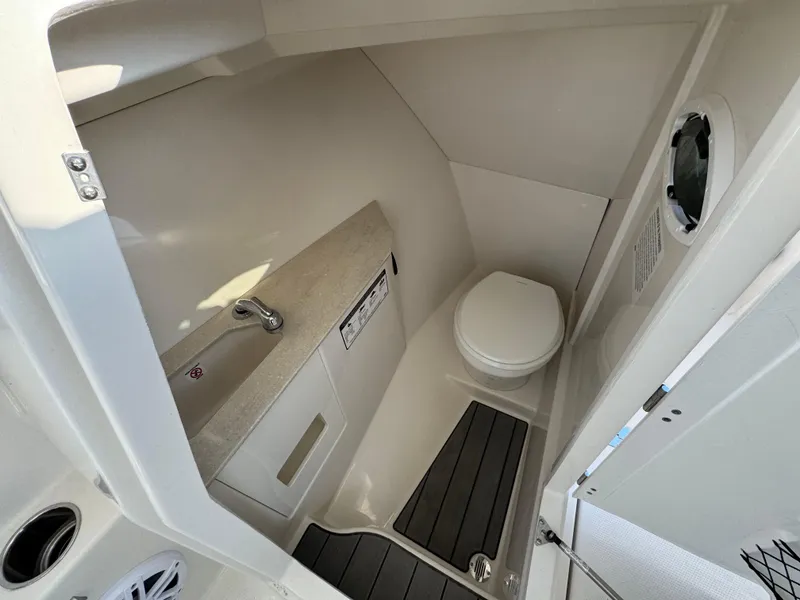 Slide: The Image of 2024 Sailfish 276 DC boat interior with compact bathroom and modern fixtures. - 17