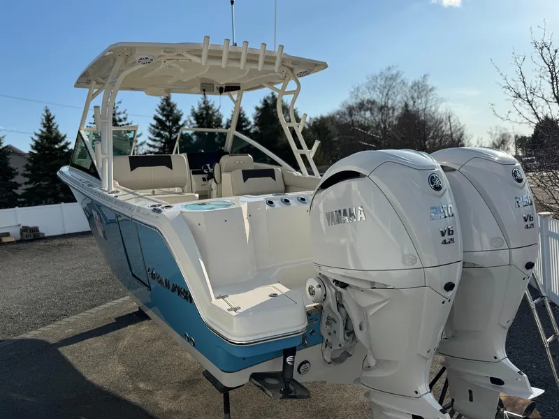 Slide: The Image of 2024 Sailfish 276 DC boat with dual Yamaha engines, parked outdoors. - 3