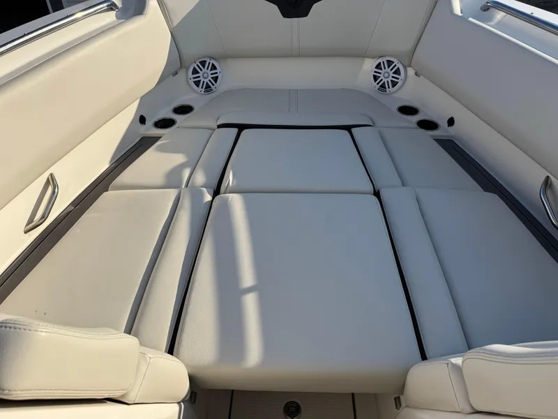 Slide: The Image of 2024 Sailfish 276 DC boat interior with cushioned seating and built-in speakers. - 5