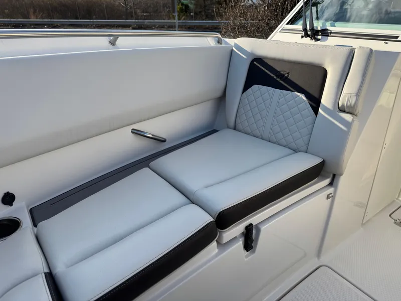 Slide: The Image of 2024 Sailfish 276 DC boat interior with cushioned seating and modern design. - 6