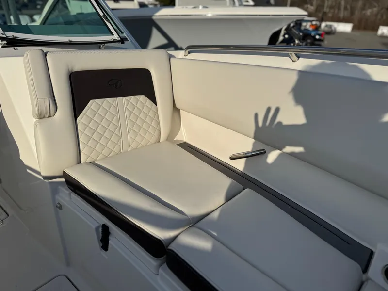 Slide: The Image of 2024 Sailfish 276 DC boat interior with cushioned seating and shadow. - 8