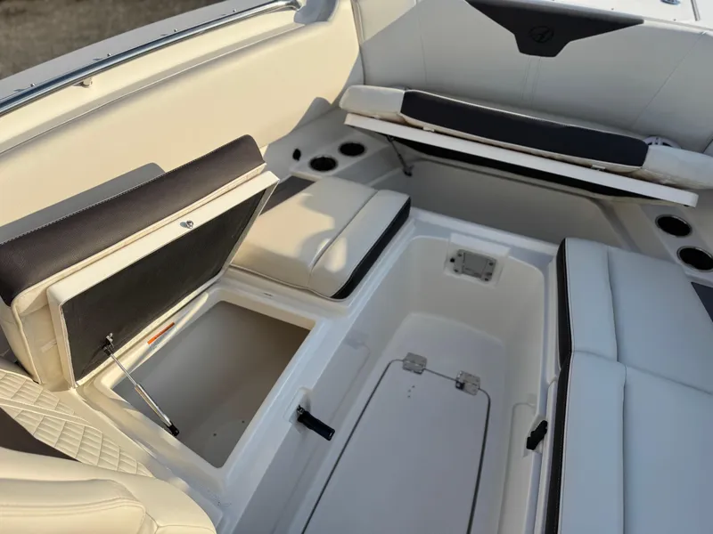 Slide: The Image of 2024 Sailfish 276 DC boat interior with open storage compartments and seating. - 9