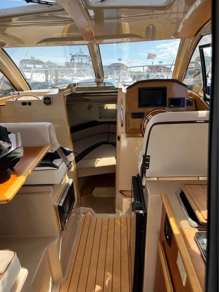 Slide: The Image of 2017 Cutwater C-242 Sport Coupe interior with wood accents and modern navigation equipment. - 10