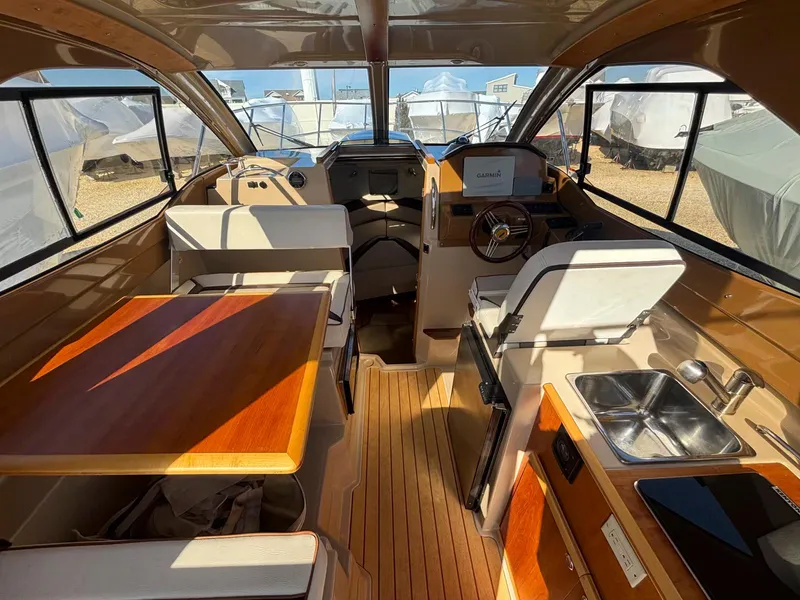 Slide: The Image of Interior of 2017 Cutwater C-242 Sport Coupe with seating, table, and kitchenette. - 11