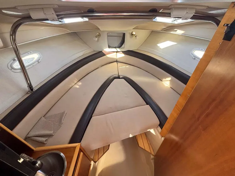 Slide: The Image of 2017 Cutwater C-242 Sport Coupe cabin interior with beige seating and wood accents. - 13