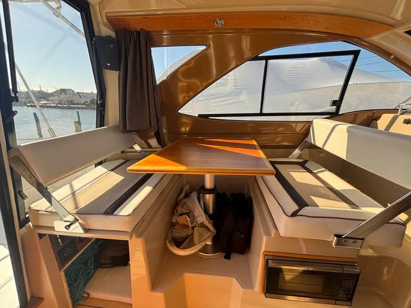 Slide: The Image of Interior of 2017 Cutwater C-242 Sport Coupe with seating and table, sunlight streaming in. - 16