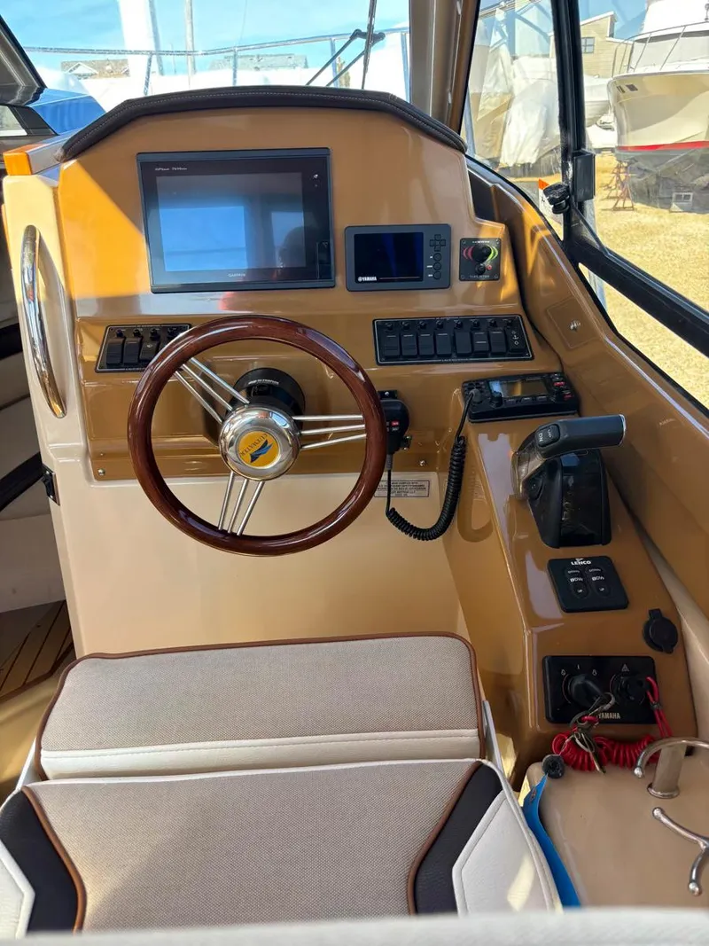 Slide: The Image of Interior helm of 2017 Cutwater C-242 Sport Coupe with steering wheel and navigation controls. - 18