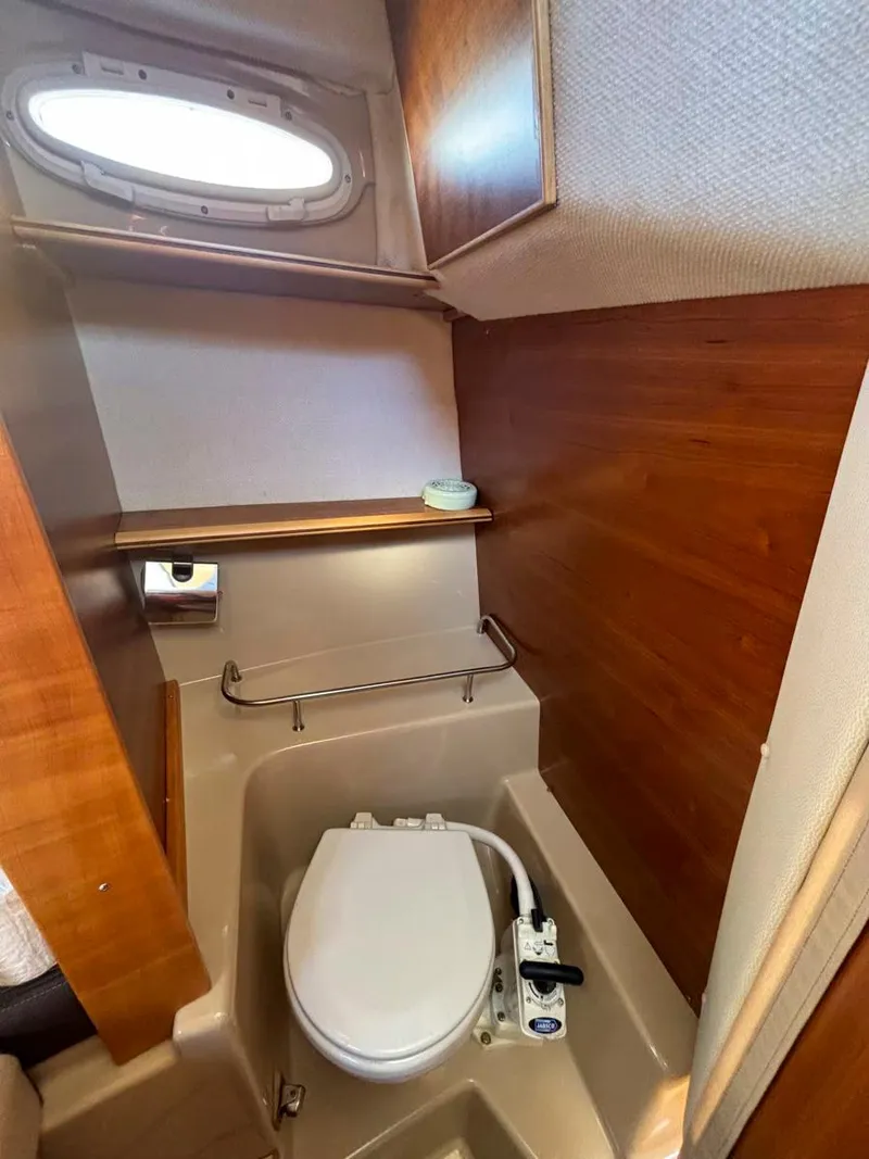 Slide: The Image of 2017 Cutwater C-242 Sport Coupe bathroom with wooden accents and compact design. - 19